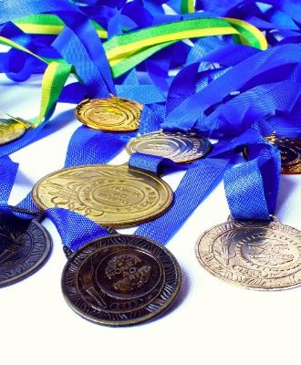  Medals/Awards laying on a table. 