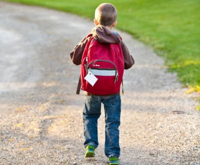 Little Boy walking with backpack. 